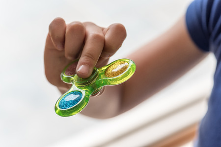 Young Girl Playing with Fidget Hand Spinnerの写真素材