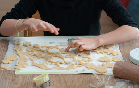 Child cooking cookies in a kitchenの写真素材