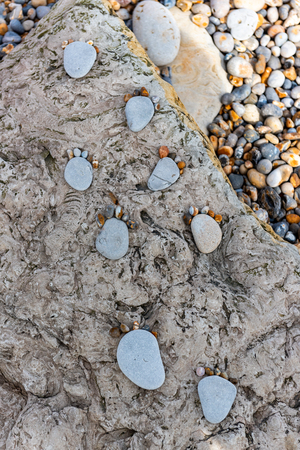 Feet Pebble stones at the beachの写真素材