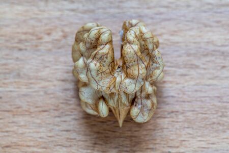 Walnut kernel on a wooden background