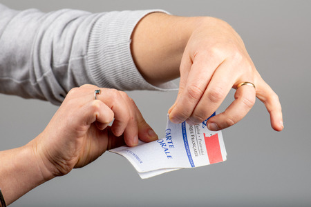 Paris,  France - November 22, 2019 : woman ripping up her voter cardのeditorial素材