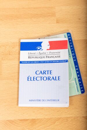France, Paris, November, 14, 2019, French electoral voter cards official government allowing to vote paper on wooden background, Franceのeditorial素材