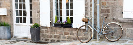 Bike placed on a house facadeの写真素材