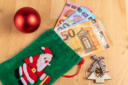 Concept money and christmas: Santa claus and euro moneyの写真素材