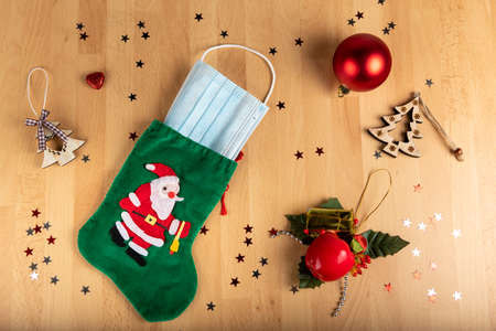Coronavirus and christmas concept on wooden background