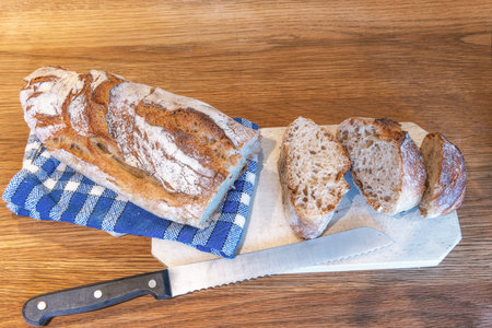 Traditional French bread on a wooden board with knife