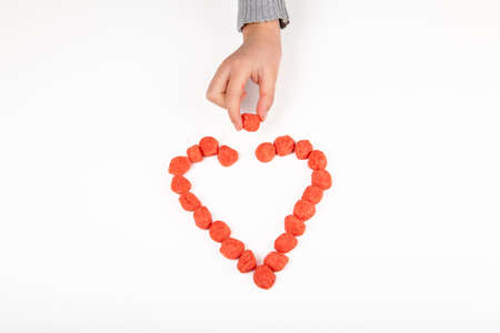 Heart made with candy on white backgroundの写真素材