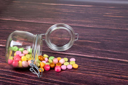 Multicolor candies in a glass jar