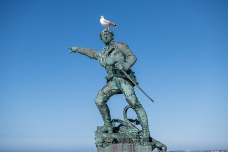 Statue of the corsair Surcouf in Saint Malo with a gull on its head, Franceのeditorial素材