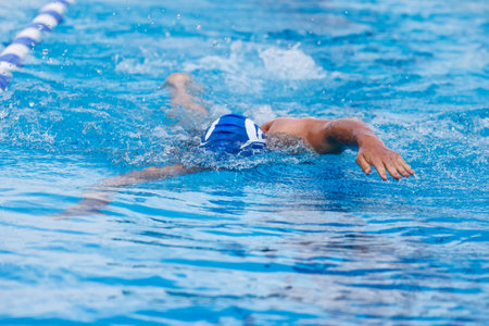 Man swimming crawl in a swimming pool