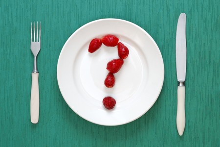 Question mark made of strawberries on the plateの写真素材