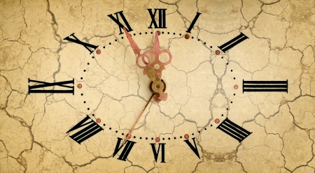 Vintage clock face on dry soil background