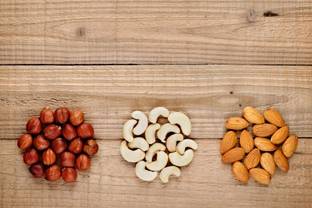 Hazelnuts, almonds and cashew nuts on wooden backgroundの写真素材