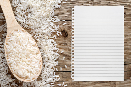 White rice and paper for recipe on wooden backgroundの写真素材