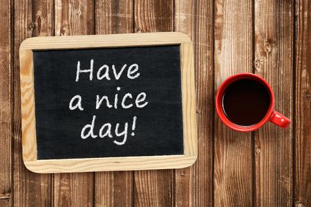 Have a nice day text on small blackboard and coffee cupの写真素材