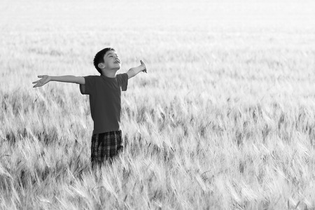 Black and white portrait of kid enjoying the sunの写真素材
