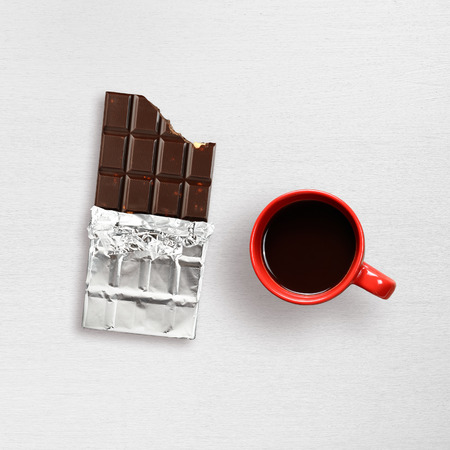Chocolate and coffee cup on white table