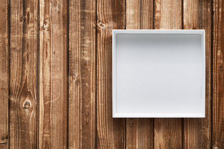 Open cardboard box on wooden background top viewの写真素材