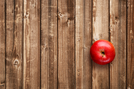 Red apple on wooden table top viewの写真素材