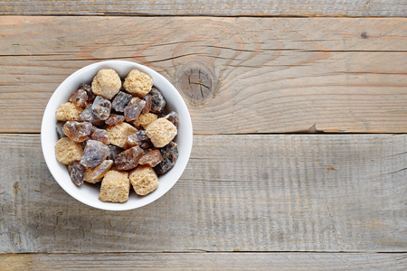 Brown sugar in bowl on wooden tableの写真素材
