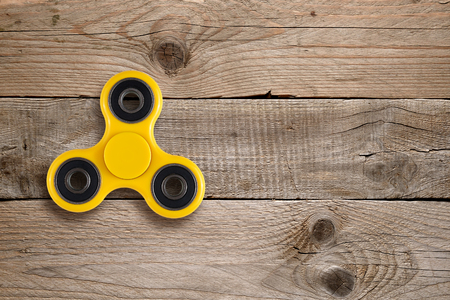 Fidget spinner toy on wooden tableの写真素材