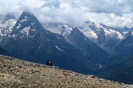 Tourists looking on Caucasus Mountains, Dombay, Russia