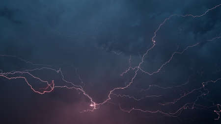 Lightnings in dark stormy skyの写真素材