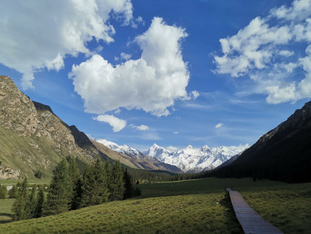 Mountain landscape with blue sky and white clouds, Kyrgyzstanの写真素材