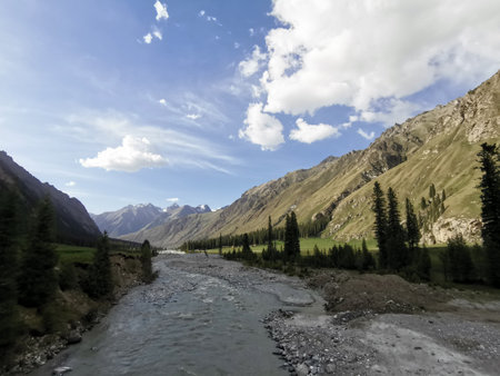 Landscape with mountain river and blue sky with white cloudsの写真素材