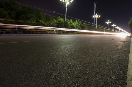 Empty asphalt road and modern skyline at nightの写真素材