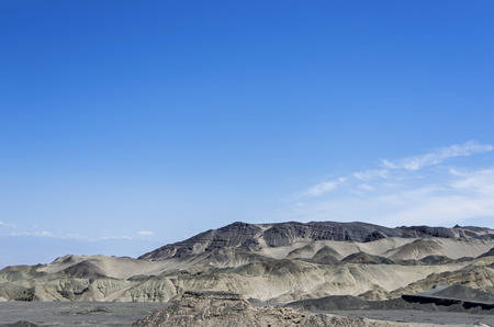 Desert hills under blue sky.