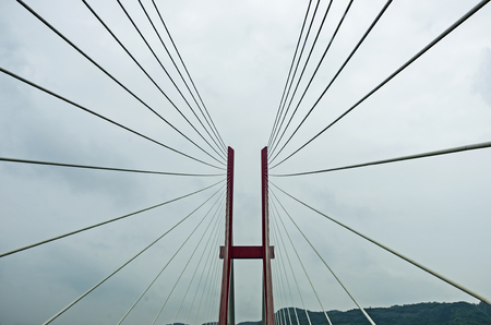 Modern bridge pylon against a blue skyの写真素材