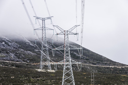 High-voltage electric wires under the blue skyの写真素材
