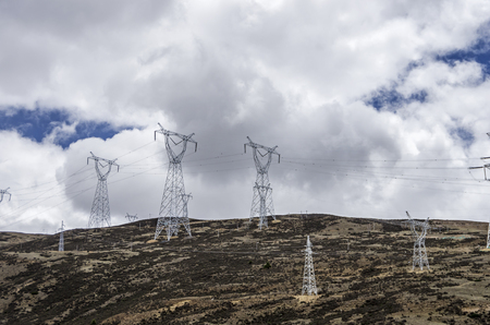 High-voltage electric wires under the blue skyの写真素材
