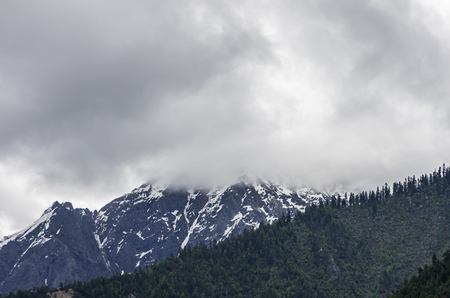 beautiful clouds and fog among frozen mountain summits landscapeの写真素材