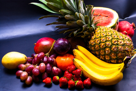 still life - various, assorted fruits on the black backgroundの写真素材