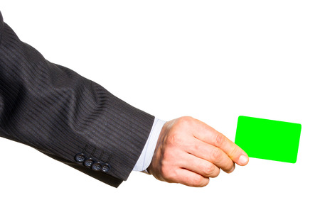 White plastic card in man hand. Isolated on whiteの写真素材