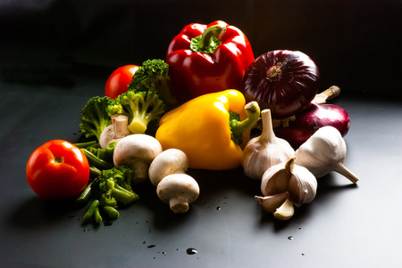 still life - set of pizza on black background - mushrooms, champignons, cauliflower, broccoli, green beans, garlicの写真素材