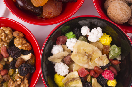 various dried fruits, mixed nuts and walnuts on the white backgroundの写真素材