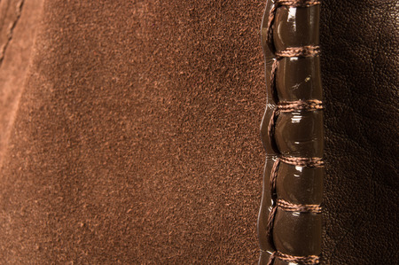 closeup of the seams on brown leather hand bag