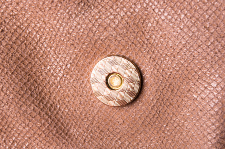 closeup of the fittings on the brown leather hand bag