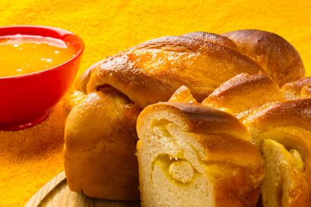 peach strudel to a wooden Board with natural honey in a red bowlの写真素材