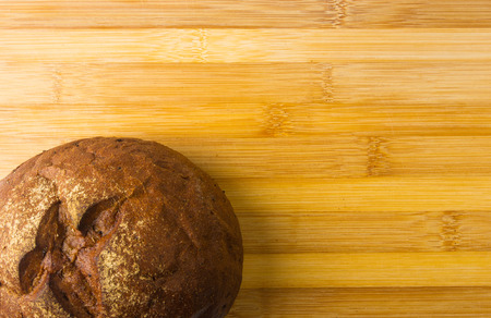 dark bread with crumbs on wood board