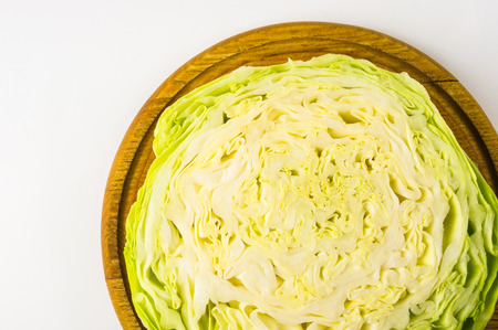 half head of Early cabbage on a wooden Board, on a white backgroundの写真素材