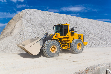 forklift - warehouse production in quarry blue clay on sky background