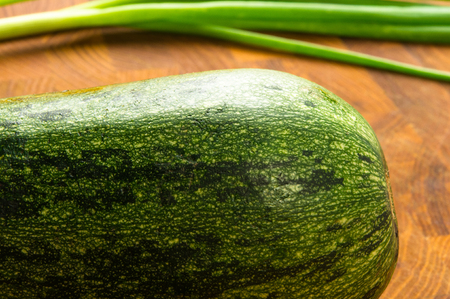 still life - zucchini and green onions on wooden Boardの写真素材