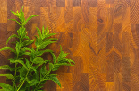 Fresh spearmint herb Mentha on a wooden background