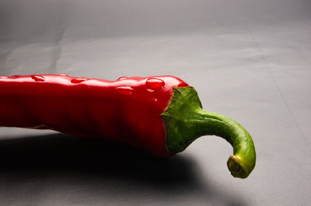 Red chili pepper on a black background