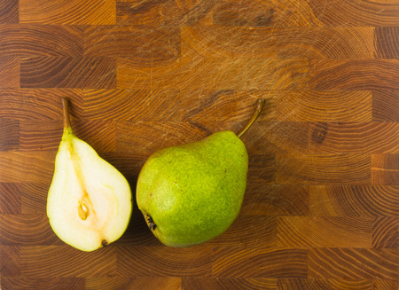 colorful pears and slices on a wooden backgroundの写真素材