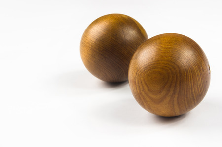 pair of wooden Chinese singing balls Baoding of health for hands on white backgroundの写真素材